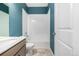 Bathroom featuring sink and vanity with shower and toilet at 3015 Pershing St, Strasburg, CO 80136