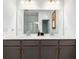 Bathroom featuring double sink vanity, tile flooring, frameless mirror, and a walk-in shower at 3015 Pershing St, Strasburg, CO 80136