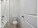 Clean bathroom featuring white tile, bathtub, and standard toilet at 3015 Pershing St, Strasburg, CO 80136