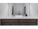 Bathroom vanity featuring double sinks, large mirror, and ample counter space at 3015 Pershing St, Strasburg, CO 80136