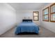 Bedroom featuring a bed with a blue comforter, carpeted floor and two windows with wooden shutters at 3015 Pershing St, Strasburg, CO 80136