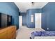 Blue bedroom with carpet and furnishings showing neutral trim and carpet at 3015 Pershing St, Strasburg, CO 80136