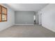 Spacious bedroom with neutral tones, plush carpeting and a window with wooden shutters at 3015 Pershing St, Strasburg, CO 80136