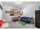A bedroom featuring a daybed, toys, decor and carpeted floors at 3015 Pershing St, Strasburg, CO 80136