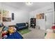 A bedroom featuring a daybed, toys, decor and carpeted floors at 3015 Pershing St, Strasburg, CO 80136