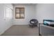 Bright bedroom features neutral walls, cozy chair, and closet at 3015 Pershing St, Strasburg, CO 80136