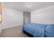 Bright bedroom featuring carpeted floor and window with wooden shutters with neutral walls at 3015 Pershing St, Strasburg, CO 80136