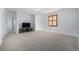 Large bonus room filled with light, neutral carpet, and a view through the window at 3015 Pershing St, Strasburg, CO 80136