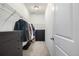 Walk-in closet with hanging racks, multiple dresser and shelving units for optimal storage at 3015 Pershing St, Strasburg, CO 80136