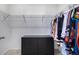 Bright walk-in closet featuring metal shelving and black dresser providing practical and organized storage at 3015 Pershing St, Strasburg, CO 80136