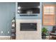 A modern fireplace with tiled surround and sleek design, paired with stylish decor and lighting at 3015 Pershing St, Strasburg, CO 80136
