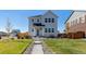 Charming two-story home featuring a well-maintained front yard and inviting entrance, enhancing curb appeal at 3015 Pershing St, Strasburg, CO 80136