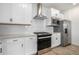 This kitchen boasts stainless steel appliances, white cabinets, and granite countertops at 3015 Pershing St, Strasburg, CO 80136