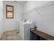 Well-organized laundry area with modern washer and dryer, functional shelving, and efficient design at 3015 Pershing St, Strasburg, CO 80136