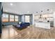 A bright and spacious living area that seamlessly transitions to the open kitchen at 3015 Pershing St, Strasburg, CO 80136