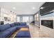 Open-concept living room and kitchen, with modern furnishings and ample natural light at 3015 Pershing St, Strasburg, CO 80136