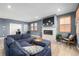 Stylish living room featuring a cozy fireplace, comfortable blue sofa, and modern decor at 3015 Pershing St, Strasburg, CO 80136