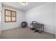 Carpeted office featuring a desk, chair, and a window with wooden shutters at 3015 Pershing St, Strasburg, CO 80136