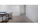 Carpeted office space with a desk, chair and neutral paint at 3015 Pershing St, Strasburg, CO 80136