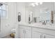 Bright bathroom with double sink vanity and modern fixtures at 17039 E Exposition Dr, Aurora, CO 80017