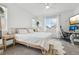 Bright bedroom featuring neutral decor, large windows, a ceiling fan, and a cozy carpet at 17039 E Exposition Dr, Aurora, CO 80017