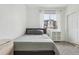 Cozy bedroom featuring a comfortable bed, natural light, and simple decor at 17039 E Exposition Dr, Aurora, CO 80017