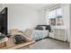 Bright bedroom with large window, neutral decor, and a comfortable bed at 17039 E Exposition Dr, Aurora, CO 80017