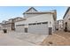 A two-car garage featuring a stone accent base, ample parking, and a well-maintained driveway at 17039 E Exposition Dr, Aurora, CO 80017
