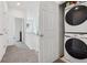 Second floor hallway and laundry closet featuring a stacked Samsung washer and dryer unit at 17039 E Exposition Dr, Aurora, CO 80017