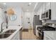 Efficient kitchen with white cabinets, stainless steel appliances and modern decor at 17039 E Exposition Dr, Aurora, CO 80017