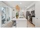 Modern kitchen with white cabinets, island with pendant lighting, and stainless steel appliances at 17039 E Exposition Dr, Aurora, CO 80017