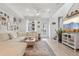 Bright living room with a large sectional sofa, TV, and modern decor at 17039 E Exposition Dr, Aurora, CO 80017