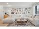 Cozy living room featuring a large comfortable sectional couch and unique gallery wall at 17039 E Exposition Dr, Aurora, CO 80017