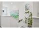 Bright staircase with carpet, white walls, a vibrant painting, and a decorative stained-glass window at 17039 E Exposition Dr, Aurora, CO 80017