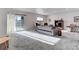 Finished basement space with a sliding door to the exterior and neutral carpet at 12668 Ulster St, Thornton, CO 80602