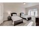 Bedroom features neutral carpet, two beds, two nightstands, and a window at 12668 Ulster St, Thornton, CO 80602