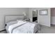 A bedroom with a queen size bed and carpeted floors with access to a full bathroom at 12668 Ulster St, Thornton, CO 80602