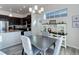 Bright dining area features a modern chandelier and a built-in buffet for added storage at 12668 Ulster St, Thornton, CO 80602