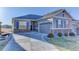Beautiful single-story home with a well-manicured lawn, stone accents, and spacious concrete driveway at 12668 Ulster St, Thornton, CO 80602