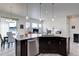 Open kitchen with granite island, pendant lighting, and a seamless flow to the dining area at 12668 Ulster St, Thornton, CO 80602
