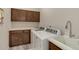 A laundry room with a white countertop, cabinets, sink, and washer and dryer at 12668 Ulster St, Thornton, CO 80602