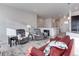 Comfortable living room with neutral tones, plush seating, and abundant natural light at 12668 Ulster St, Thornton, CO 80602