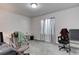 A home office features neutral carpet, a window and 2 rolling chairs at 12668 Ulster St, Thornton, CO 80602