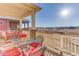 Inviting covered porch featuring a table with red chairs and views of the open landscape at 12668 Ulster St, Thornton, CO 80602