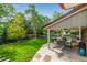 Inviting backyard patio with outdoor dining area and lush lawn at 3720 S Willow Cir, Denver, CO 80237