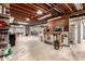 Spacious basement with exposed beams, a workbench, and ample storage space at 3720 S Willow Cir, Denver, CO 80237