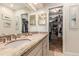 Updated bathroom showcasing granite countertop vanity and view into walk-in closet at 3720 S Willow Cir, Denver, CO 80237
