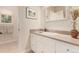 Bathroom featuring a large vanity with sink and a separate door to the commode at 3720 S Willow Cir, Denver, CO 80237