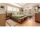Bright bedroom with wood floors, multiple windows with shutters, and contemporary decor at 3720 S Willow Cir, Denver, CO 80237