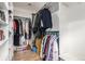 Walk-in closet with custom shelving, ample storage space, and clothing racks at 3720 S Willow Cir, Denver, CO 80237